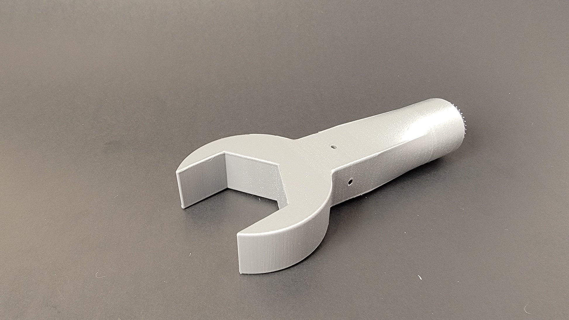 Vent holes for odour permeation of wrench shaped scent container used in nose work training and competition 
