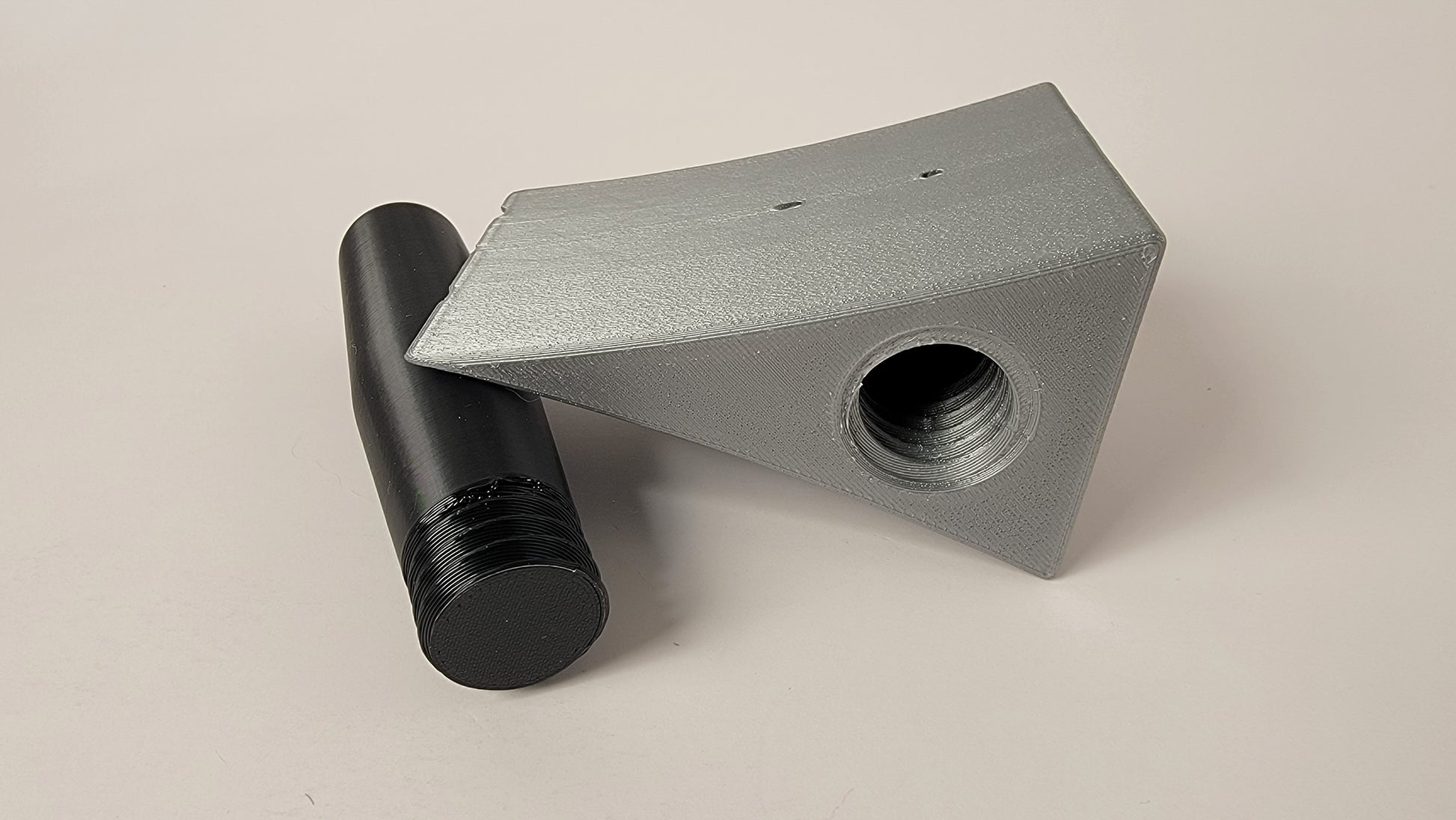 Close up of axe shaped scent container for canine nose work