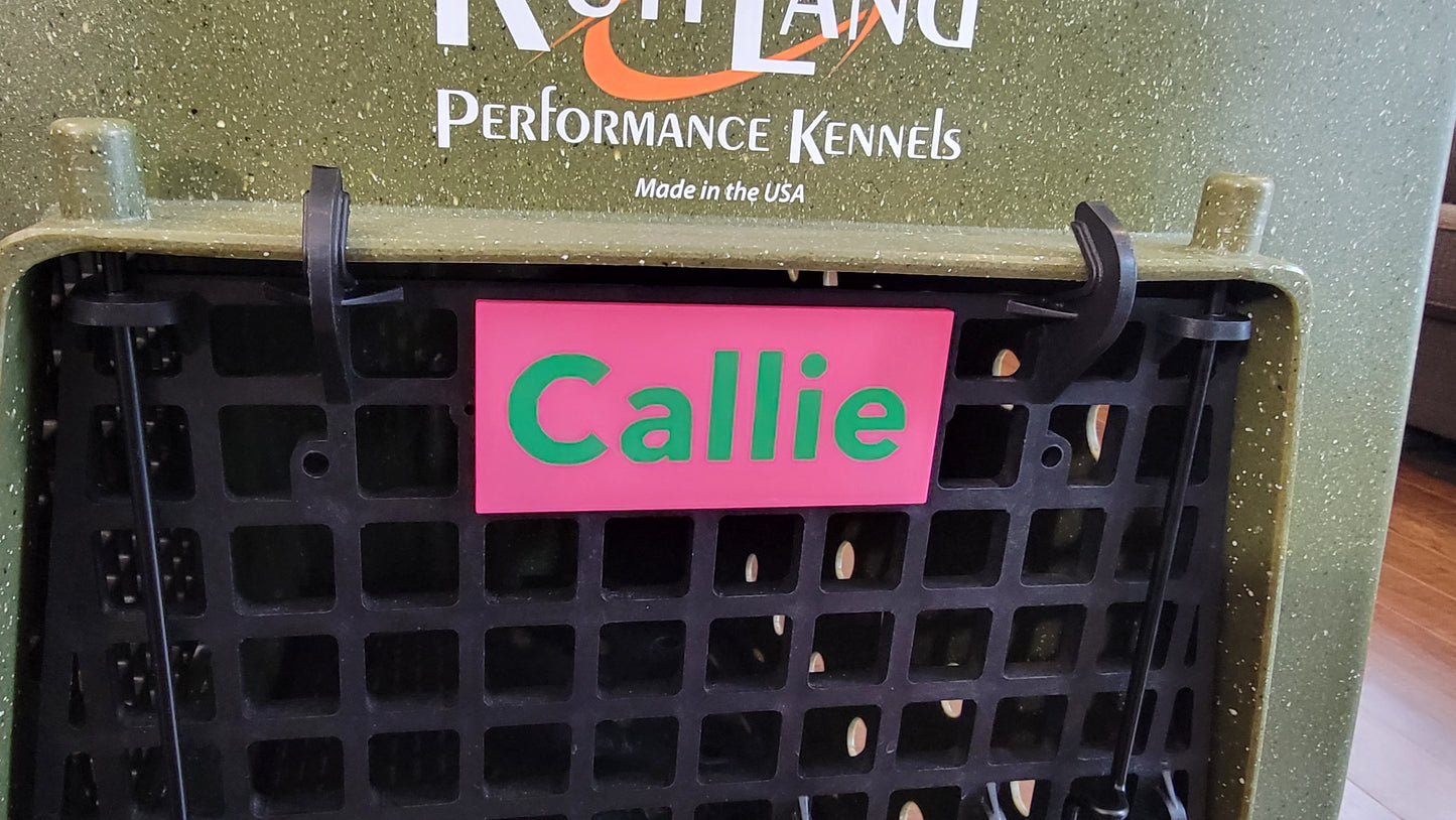 Ruffland kennel name plate snapped onto kennel door